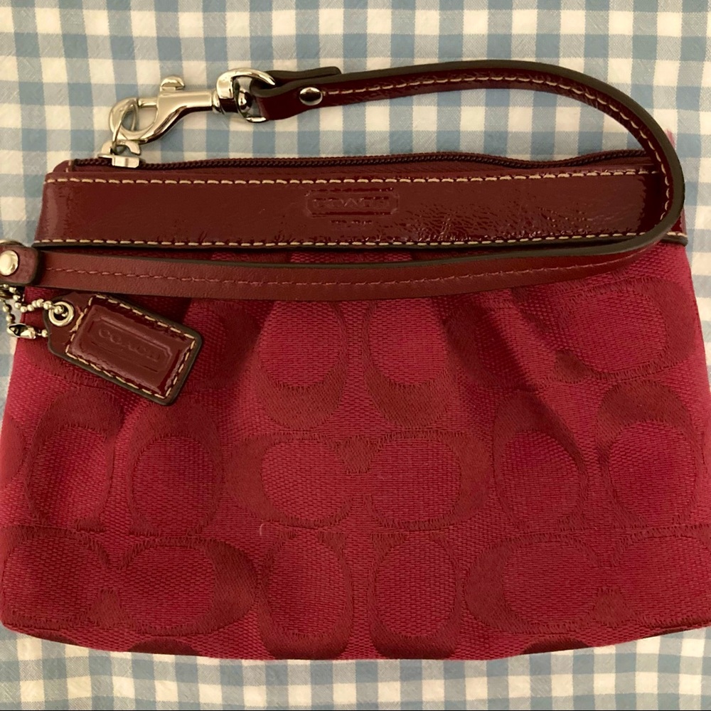 Coach wristlet in a cranberry colour. Gifted and never worn.